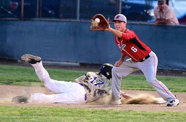 Lemoore's Bristol Hitchman returns safely to first base beneath the outstretched glove of Hanford's Trever Furtado.
